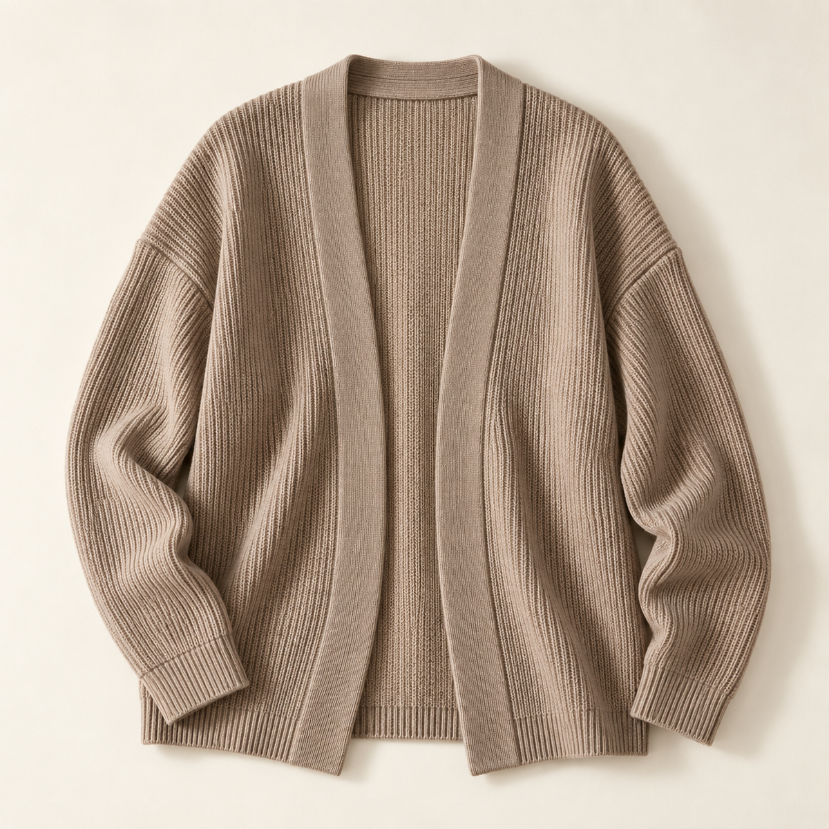 Relaxed taupe open-front knit cardigan concept on warm ivory background